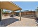 Inviting covered patio with stylish pavers, wooden pergola, and lush greenery for outdoor relaxation at 17421 N 14Th St, Phoenix, AZ 85022
