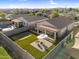 Aerial view of backyard featuring a putting green, patio seating area, covered patio, and pool in neighboring yard at 1747 E Grove St, Phoenix, AZ 85040
