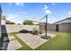 Cozy backyard patio with comfortable seating, fire pit, and umbrella, creating a relaxing outdoor space at 1747 E Grove St, Phoenix, AZ 85040