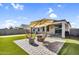 Outdoor patio with an umbrella, charming seating area, and putting green in the backyard at 1747 E Grove St, Phoenix, AZ 85040