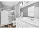 Bright bathroom with double vanity, modern fixtures, a glass shower, and neutral finishes at 1747 E Grove St, Phoenix, AZ 85040
