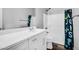 Bright bathroom with a modern white vanity and playful shower curtain, creating a cheerful space at 1747 E Grove St, Phoenix, AZ 85040