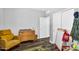 Cozy bedroom featuring a wooden dresser, comfortable chair, and a fun, dinosaur-themed rug, perfect for a  at 1747 E Grove St, Phoenix, AZ 85040