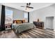 Bright main bedroom features wood-look floors, neutral walls, and large windows for natural light at 1747 E Grove St, Phoenix, AZ 85040