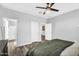 Neutral bedroom features wood-look floors, a ceiling fan, and access to the ensuite bathroom at 1747 E Grove St, Phoenix, AZ 85040