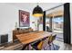 Dining area features a wooden table, modern chairs, stylish lighting, and sliding glass doors to the patio at 1747 E Grove St, Phoenix, AZ 85040