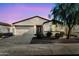 Charming single-story home featuring a neutral color scheme, low maintenance landscaping, and attached two car garage at 1747 E Grove St, Phoenix, AZ 85040