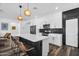 Modern kitchen features a large island with seating, stainless steel appliances, and stylish black backsplash at 1747 E Grove St, Phoenix, AZ 85040
