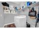 Functional laundry room featuring a modern washer and dryer, along with ample storage shelves for supplies at 1747 E Grove St, Phoenix, AZ 85040
