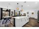 Open-concept living space with a dining area, modern lighting, and access to the outdoor patio at 1747 E Grove St, Phoenix, AZ 85040