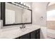 Stylish bathroom featuring a white quartz countertop, black cabinetry, and a sleek matte black faucet and hardware at 1802 W Isleta Ave, Mesa, AZ 85202
