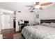 Primary bedroom featuring a ceiling fan, wood floors, and a view of the closet at 1802 W Isleta Ave, Mesa, AZ 85202