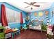 ' bedroom featuring hardwood floors, murals, and a rocking chair at 1802 W Isleta Ave, Mesa, AZ 85202
