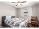 Bedroom featuring hardwood floors, a chair with a pillow, and large window at 1802 W Isleta Ave, Mesa, AZ 85202
