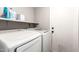 Clean laundry room with a modern white washer and dryer set, and practical shelving at 1802 W Isleta Ave, Mesa, AZ 85202