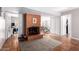Living room featuring a brick fireplace, neutral walls, and classic tile flooring at 1802 W Isleta Ave, Mesa, AZ 85202