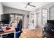 Office with tile floor, large window, ceiling fan, and adjacent sitting room visible through glass doors at 1802 W Isleta Ave, Mesa, AZ 85202