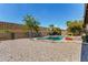 Backyard pool area with desert landscaping and privacy fencing at 1802 W Isleta Ave, Mesa, AZ 85202
