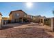 Spacious backyard with rock landscaping, a covered patio, and a fenced perimeter for privacy at 181 N 222Nd Dr, Buckeye, AZ 85326