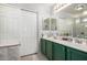 Clean bathroom featuring double sinks, updated fixtures, and a large mirror at 181 N 222Nd Dr, Buckeye, AZ 85326