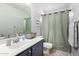 Cozy bathroom featuring a vanity with stylish accessories, and a shower with a decorative curtain at 181 N 222Nd Dr, Buckeye, AZ 85326