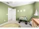 Serene Bedroom with soft green walls and playful decor, creating a cozy space with natural light at 181 N 222Nd Dr, Buckeye, AZ 85326