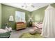 Charming Bedroom featuring a crib, dresser, and stylish decor with a whimsical and playful atmosphere at 181 N 222Nd Dr, Buckeye, AZ 85326