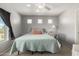Serene bedroom with neutral walls, cozy bedding, and a ceiling fan at 181 N 222Nd Dr, Buckeye, AZ 85326
