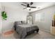 Comfortable bedroom with a ceiling fan, plush carpeting and soft natural light at 181 N 222Nd Dr, Buckeye, AZ 85326