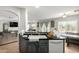 Kitchen area showcasing a breakfast bar, updated appliances, and ample countertop space at 181 N 222Nd Dr, Buckeye, AZ 85326