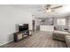 Open concept living room with modern decor, wood floors, and ample space for entertaining at 181 N 222Nd Dr, Buckeye, AZ 85326