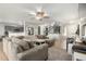 Open-concept living space with neutral tones, tile flooring, and abundant natural light at 181 N 222Nd Dr, Buckeye, AZ 85326