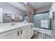 Updated bathroom features dual sinks, a large mirror, and a shower-tub combo at 18195 W Marshall Ln, Surprise, AZ 85388