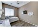 Cozy bedroom featuring hardwood floors, a window, and a comfortable bed at 18195 W Marshall Ln, Surprise, AZ 85388