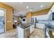Modern kitchen with stainless steel appliances, island with granite countertops, and open floor plan at 18195 W Marshall Ln, Surprise, AZ 85388