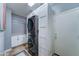 Well-equipped laundry room featuring a stackable washer/dryer and storage cabinets near the door at 18195 W Marshall Ln, Surprise, AZ 85388