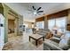 Inviting living room featuring a ceiling fan, tile floors, and neutral paint at 18195 W Marshall Ln, Surprise, AZ 85388