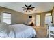 Spacious main bedroom with soft carpet, ceiling fan, and a walk-in closet at 18195 W Marshall Ln, Surprise, AZ 85388