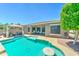 Inviting backyard pool with lounge area, covered patio, and mature landscaping at 18195 W Marshall Ln, Surprise, AZ 85388