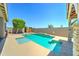 Refreshing backyard pool with a tanning ledge and lush landscaping in a private yard at 18195 W Marshall Ln, Surprise, AZ 85388