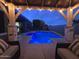 Inviting backyard pool under a covered patio, perfect for evening relaxation at 18195 W Marshall Ln, Surprise, AZ 85388