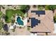 Aerial view of home with solar panels, pool, spa, lush landscaping, and fire pit at 18329 W Montebello Ave, Litchfield Park, AZ 85340