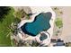 Aerial view of backyard pool, spa, and desert landscaping with cacti and palm trees at 18329 W Montebello Ave, Litchfield Park, AZ 85340