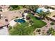 Backyard aerial view featuring desert landscaping, artificial turf, pool, spa, and fire pit at 18329 W Montebello Ave, Litchfield Park, AZ 85340