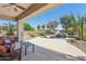 Beautiful backyard featuring covered patio, waterfall pool, lush landscaping, and an outdoor grill at 18329 W Montebello Ave, Litchfield Park, AZ 85340