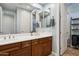 Bathroom featuring double sinks, wood cabinets and tile floors at 18329 W Montebello Ave, Litchfield Park, AZ 85340