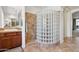 Bathroom featuring a vanity with wood cabinets, tile floors, and a glass block shower at 18329 W Montebello Ave, Litchfield Park, AZ 85340