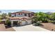 Beautiful two-story home featuring a stone-accented facade, a red tile roof, and a spacious three-car garage at 18329 W Montebello Ave, Litchfield Park, AZ 85340