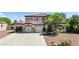 Beautiful two-story home featuring a stone-accented facade, a red tile roof, and a spacious three-car garage at 18329 W Montebello Ave, Litchfield Park, AZ 85340