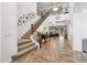 Inviting foyer with soaring ceilings, tile flooring, staircase, and views into the living room at 18329 W Montebello Ave, Litchfield Park, AZ 85340